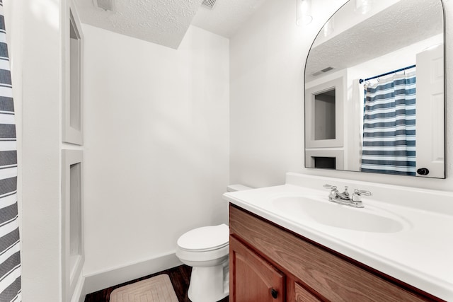 524 W Woodbine Rd, Nixa, MO 65714 - full bath with a textured ceiling, toilet, vanity, wood finished floors, and a shower with curtain