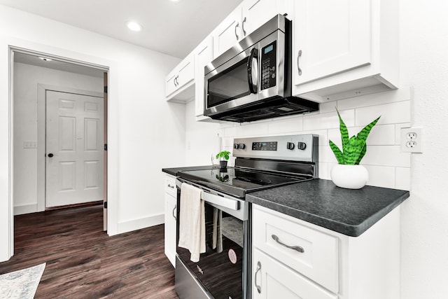 524 W Woodbine Rd, Nixa, MO 65714 - kitchen with appliances with stainless steel finishes, dark countertops, tasteful backsplash, white cabinetry, and recessed lighting