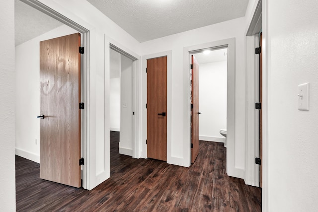 524 W Woodbine Rd, Nixa, MO 65714 - hall featuring dark wood finished floors, baseboards, and a textured ceiling