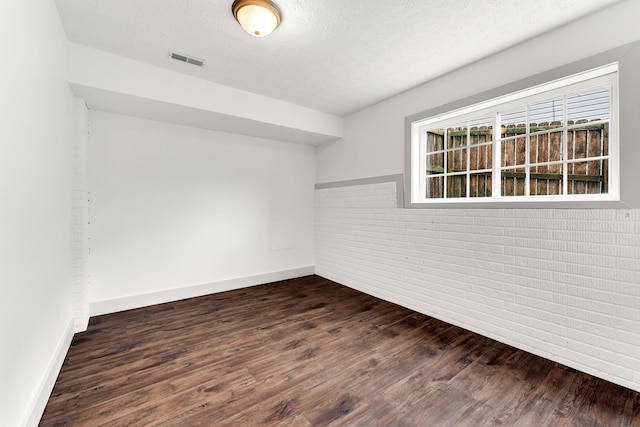 524 W Woodbine Rd, Nixa, MO 65714 - spare room featuring dark wood-style floors, baseboards, and a textured ceiling