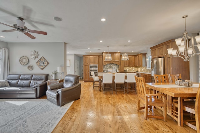 1865 N Hearthstone Ln, Strafford, MO 65757 - living room featuring light wood-type flooring, recessed lighting, a ceiling fan, and a chandelier