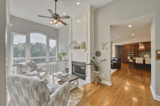 1865 N Hearthstone Ln, Strafford, MO 65757 - living room featuring ceiling fan, recessed lighting, a fireplace, light wood finished floors, and baseboards