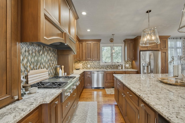 1865 N Hearthstone Ln, Strafford, MO 65757 - kitchen with stainless steel appliances, a sink, brown cabinets, and recessed lighting