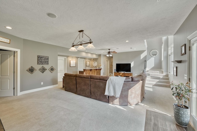 1865 N Hearthstone Ln, Strafford, MO 65757 - carpeted living room with ceiling fan, a textured ceiling, baseboards, and recessed lighting