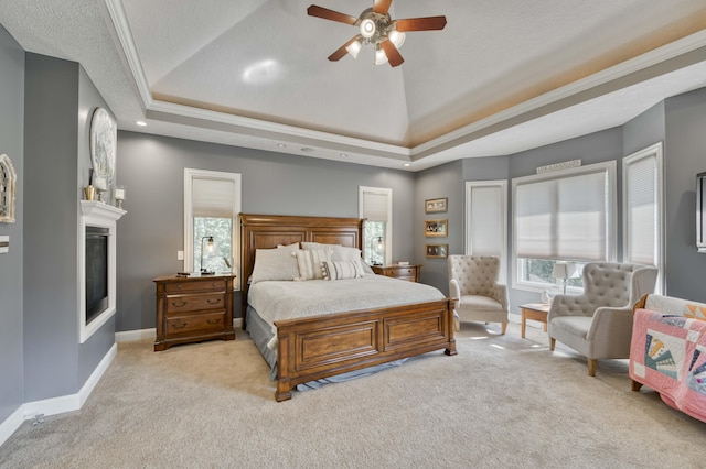 1865 N Hearthstone Ln, Strafford, MO 65757 - bedroom featuring light carpet, a fireplace, a raised ceiling, baseboards, and crown molding