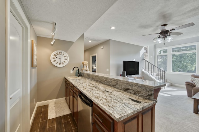 1865 N Hearthstone Ln, Strafford, MO 65757 - kitchen featuring a peninsula, baseboards, stainless steel dishwasher, open floor plan, and a sink