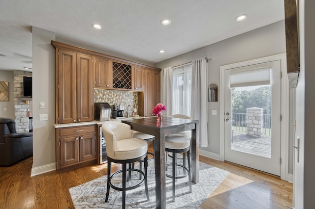 1865 N Hearthstone Ln, Strafford, MO 65757 - dining room featuring bar area, light wood-type flooring, recessed lighting, and baseboards