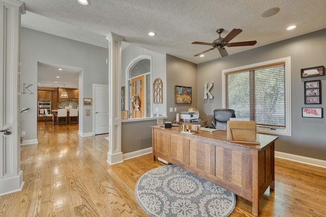 1865 N Hearthstone Ln, Strafford, MO 65757 - office space featuring ornate columns, light wood-type flooring, a ceiling fan, recessed lighting, and a textured ceiling