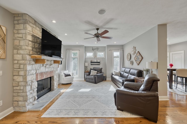 1865 N Hearthstone Ln, Strafford, MO 65757 - living room with a stone fireplace, baseboards, ceiling fan, wood finished floors, and recessed lighting