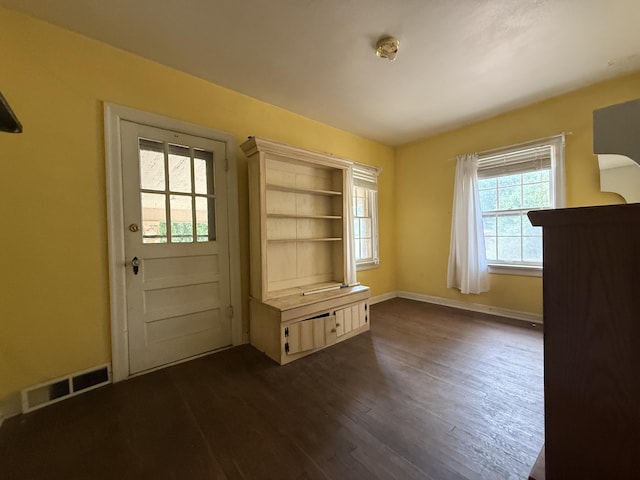 404 S 5th St, Thayer, MO 65791 - unfurnished dining area featuring dark wood-type flooring and baseboards