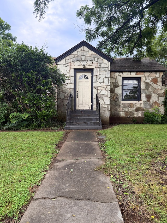404 S 5th St, Thayer, MO 65791 - view of front facade with stone siding, a front yard, and entry steps