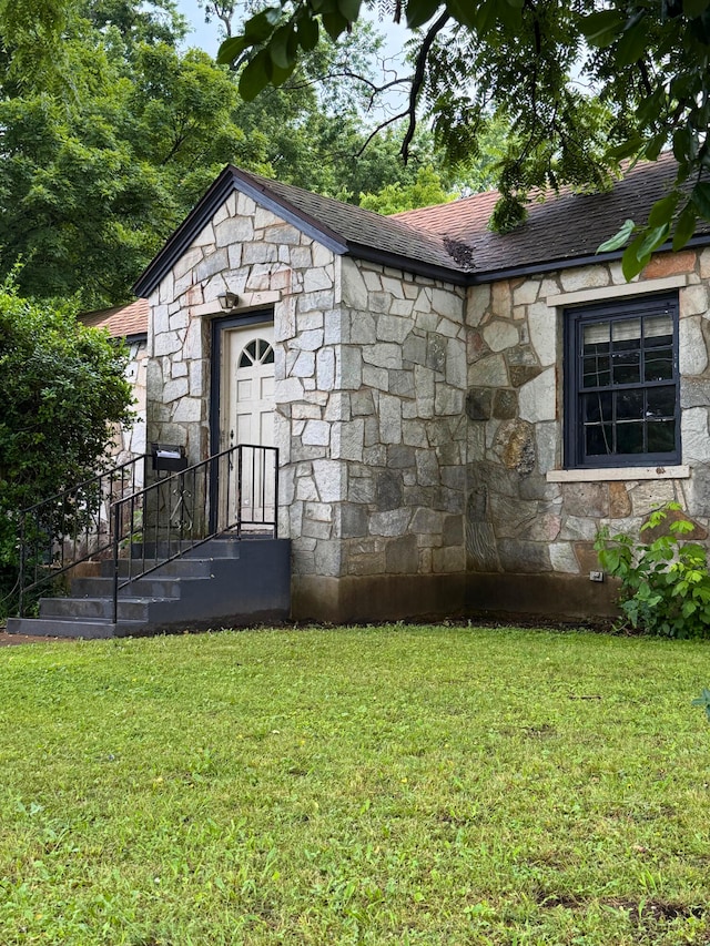 404 S 5th St, Thayer, MO 65791 - view of property exterior featuring stone siding, a shingled roof, and a lawn