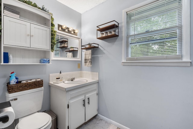 668 W Springfield St, Aurora, MO 65605 - bathroom with vanity, toilet, and baseboards