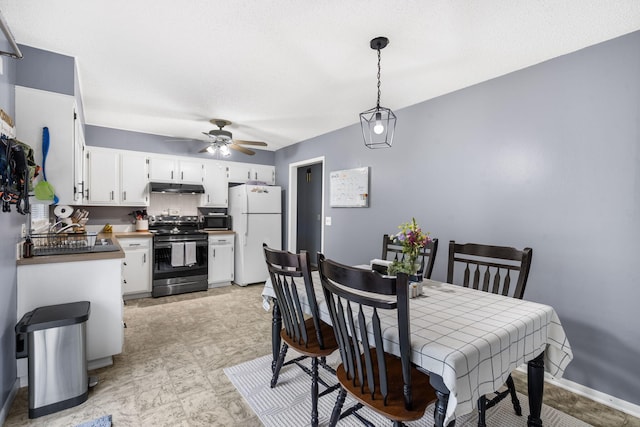 668 W Springfield St, Aurora, MO 65605 - dining area with a ceiling fan and baseboards
