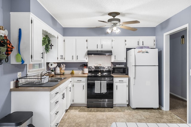 668 W Springfield St, Aurora, MO 65605 - kitchen featuring appliances with stainless steel finishes, under cabinet range hood, a sink, ceiling fan, and white cabinets