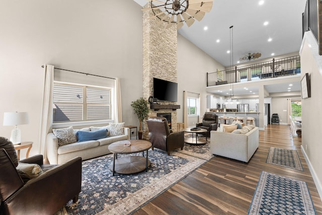 440 Lake Front Dr, Branson, MO 65616 - living room with dark wood-style floors, a high ceiling, a fireplace, ceiling fan, and baseboards