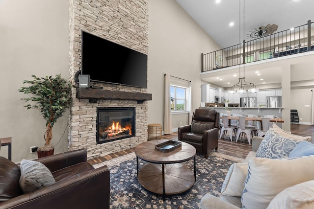 440 Lake Front Dr, Branson, MO 65616 - living area featuring wood finished floors, a stone fireplace, a high ceiling, baseboards, and recessed lighting