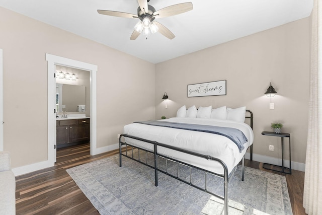 440 Lake Front Dr, Branson, MO 65616 - bedroom with dark wood-style floors, baseboards, connected bathroom, and a sink