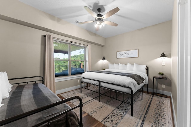 440 Lake Front Dr, Branson, MO 65616 - bedroom featuring baseboards, wood finished floors, and ceiling fan