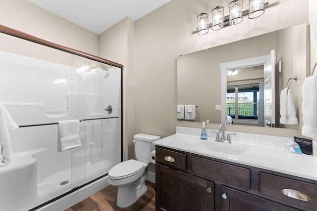 440 Lake Front Dr, Branson, MO 65616 - bathroom featuring a stall shower, wood finished floors, toilet, vanity, and ensuite bathroom