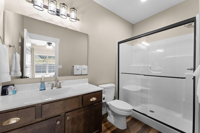 440 Lake Front Dr, Branson, MO 65616 - full bath featuring wood finished floors, a stall shower, vanity, toilet, and ceiling fan