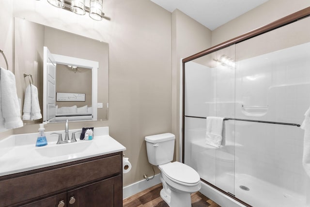440 Lake Front Dr, Branson, MO 65616 - bathroom featuring wood finished floors, vanity, a stall shower, toilet, and baseboards