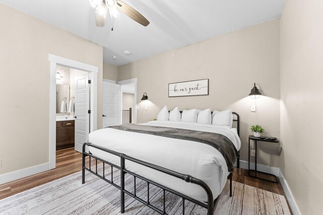 440 Lake Front Dr, Branson, MO 65616 - bedroom featuring baseboards, light wood-style flooring, ensuite bathroom, and a ceiling fan
