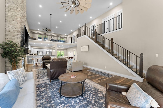 440 Lake Front Dr, Branson, MO 65616 - living room featuring wood finished floors, a towering ceiling, recessed lighting, a chandelier, and stairs