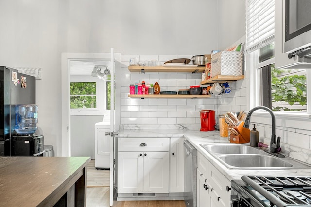 1609 N Lyon Ave, Springfield, MO 65803 - kitchen featuring a sink, appliances with stainless steel finishes, backsplash, and white cabinetry