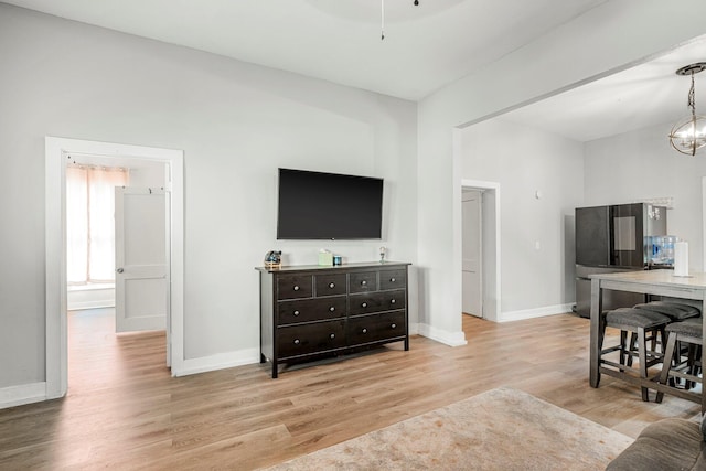 1609 N Lyon Ave, Springfield, MO 65803 - living area with light wood-type flooring, baseboards, and a chandelier