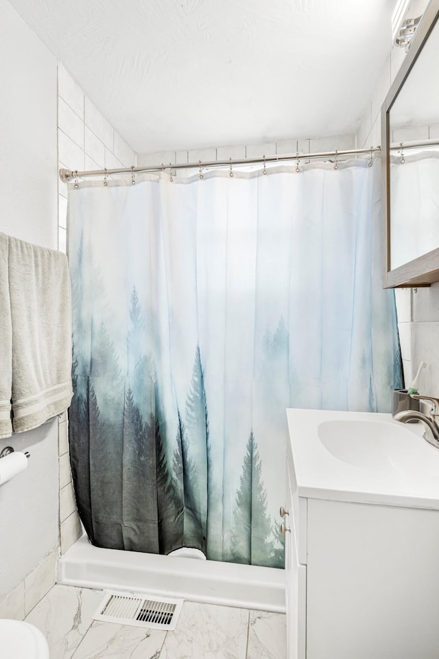 1609 N Lyon Ave, Springfield, MO 65803 - bathroom with vanity, marble finish floors, curtained shower, and toilet