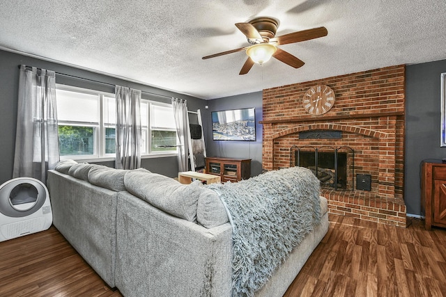 2052 N Grant Ave, Springfield, MO 65803 - living area with a textured ceiling, a ceiling fan, wood finished floors, and a fireplace