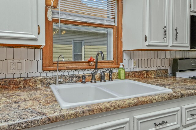 2052 N Grant Ave, Springfield, MO 65803 - kitchen with a sink, white cabinets, and tasteful backsplash