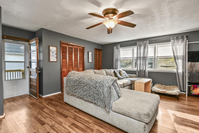 2052 N Grant Ave, Springfield, MO 65803 - living room with ceiling fan, a textured ceiling, baseboards, and wood finished floors