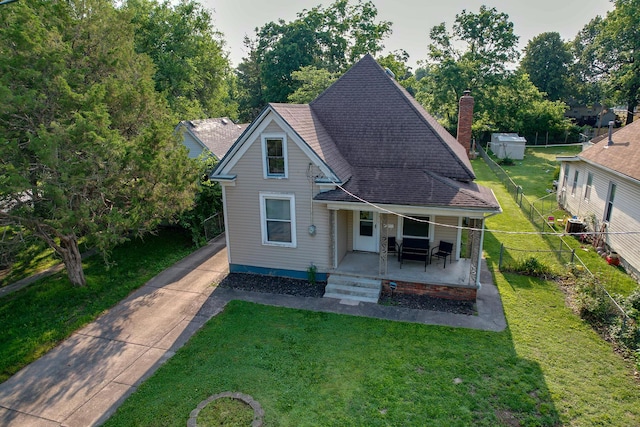 2052 N Grant Ave, Springfield, MO 65803 - view of front of house featuring a porch, a chimney, a shingled roof, central AC unit, and concrete driveway