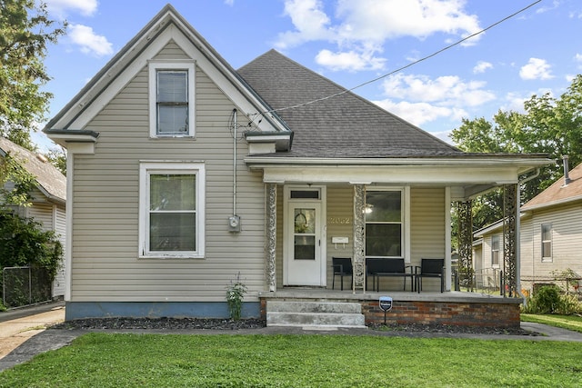 2052 N Grant Ave, Springfield, MO 65803 - view of front facade featuring a porch, a front lawn, and roof with shingles