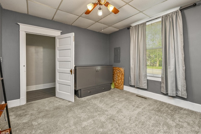 2052 N Grant Ave, Springfield, MO 65803 - unfurnished bedroom with carpet floors, a paneled ceiling, electric panel, baseboards, and a ceiling fan