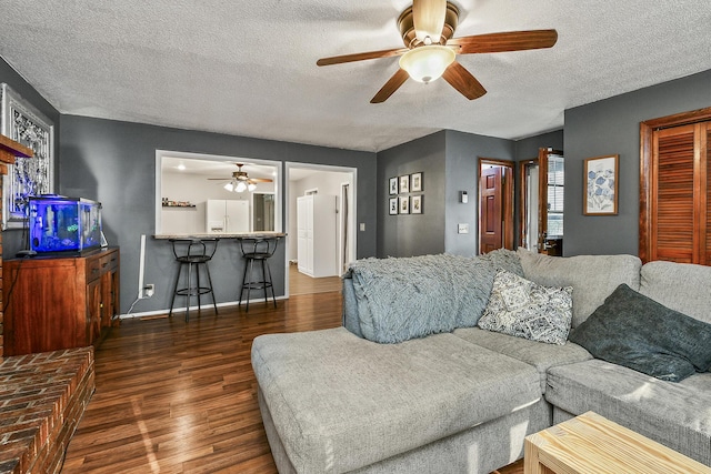 2052 N Grant Ave, Springfield, MO 65803 - living area with a ceiling fan, wood finished floors, a textured ceiling, and baseboards