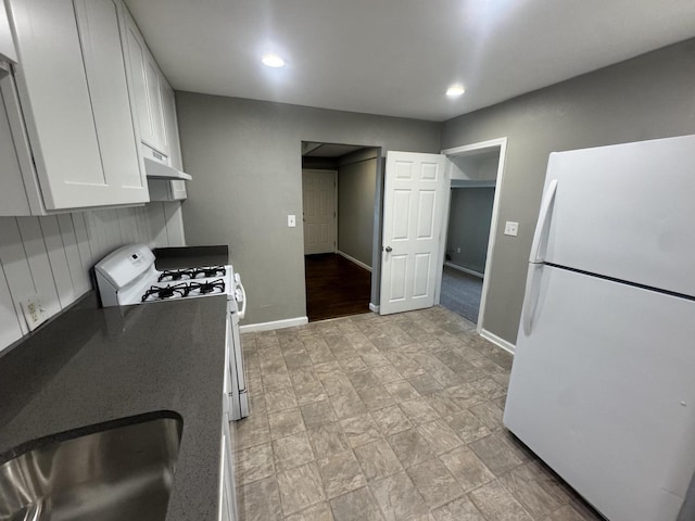 2152 E Cairo St, Springfield, MO 65802 - kitchen featuring white appliances, white cabinetry, baseboards, a sink, and recessed lighting