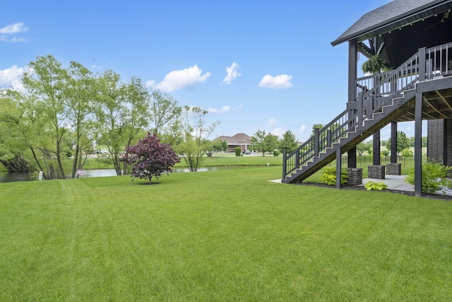 7015 Calabash St, Nixa, MO 65714 - view of grassy yard featuring stairs and a water view
