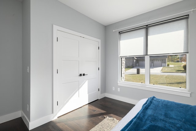 7015 Calabash St, Nixa, MO 65714 - bedroom featuring dark wood-type flooring and baseboards