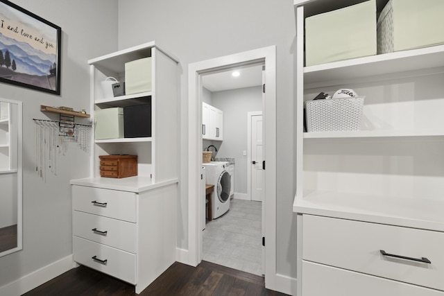 7015 Calabash St, Nixa, MO 65714 - laundry room featuring cabinet space, dark wood-style flooring, baseboards, and washing machine and clothes dryer