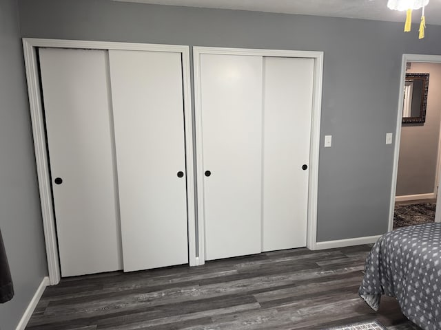 27641 County Road 356, Pittsburg, MO 65724 - bedroom with multiple closets, dark wood-style flooring, and baseboards