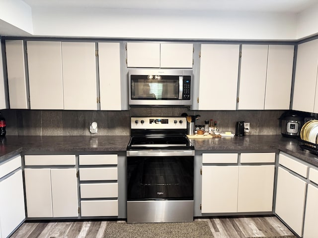 27641 County Road 356, Pittsburg, MO 65724 - kitchen featuring appliances with stainless steel finishes, dark countertops, and light wood-style flooring