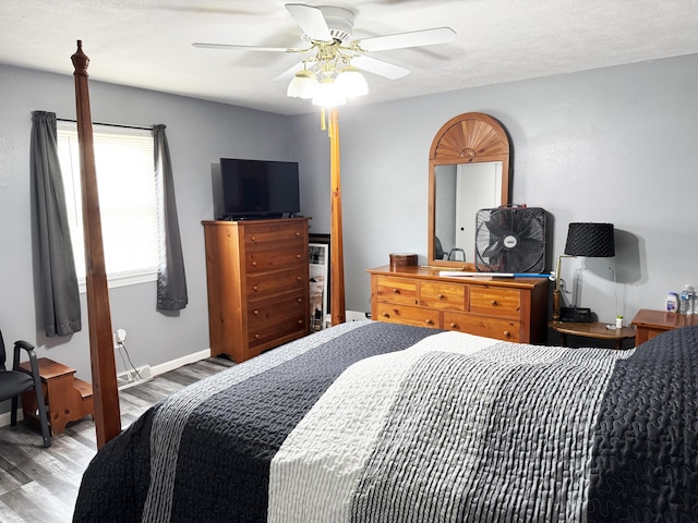 27641 County Road 356, Pittsburg, MO 65724 - bedroom featuring wood finished floors, a ceiling fan, and baseboards