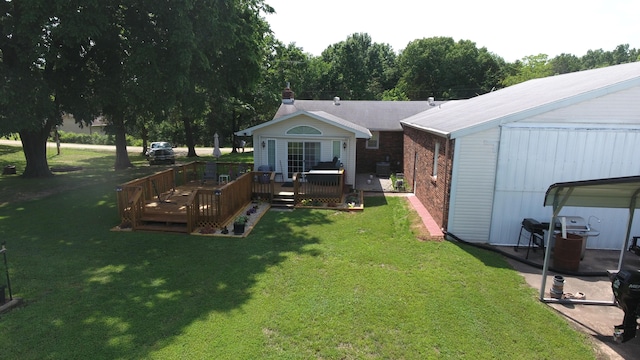 27641 County Road 356, Pittsburg, MO 65724 - back of house with a wooden deck, a lawn, and brick siding