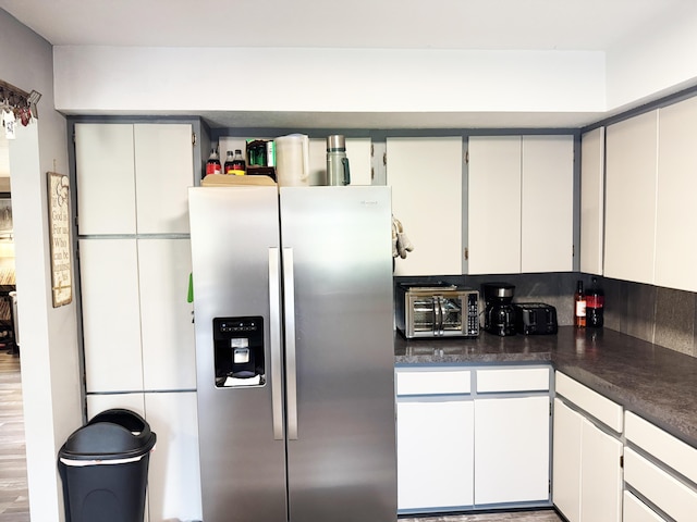27641 County Road 356, Pittsburg, MO 65724 - kitchen featuring stainless steel fridge with ice dispenser and dark countertops