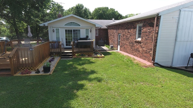 27641 County Road 356, Pittsburg, MO 65724 - back of property featuring a lawn, brick siding, and a deck