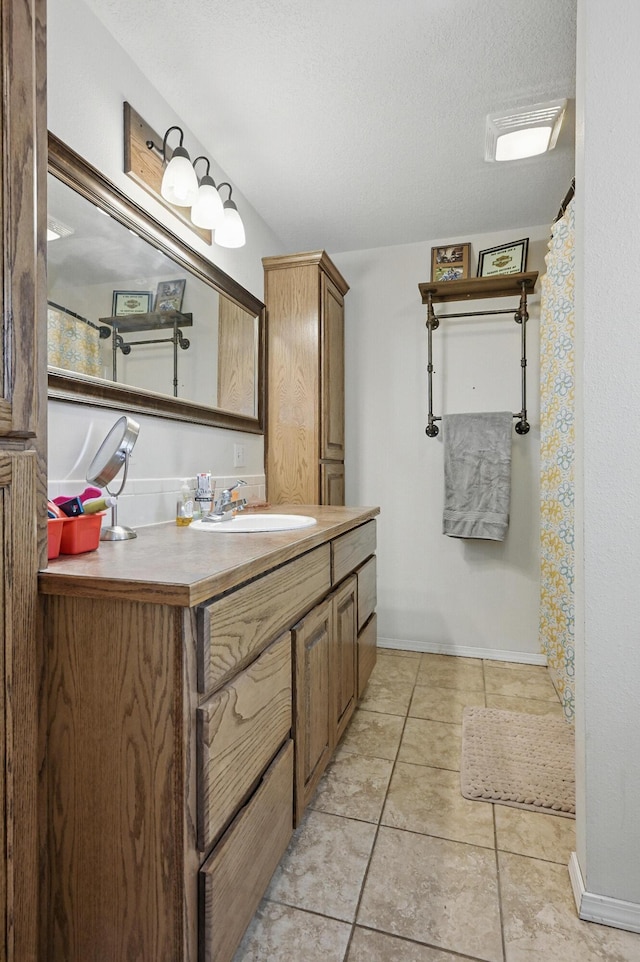 1142 Rte F, Anderson, MO 64831 - bathroom with vanity, baseboards, tile patterned floors, and a textured ceiling