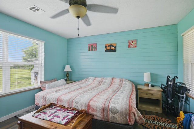 1142 Rte F, Anderson, MO 64831 - bedroom featuring wood finished floors, wooden walls, ceiling fan, and baseboards